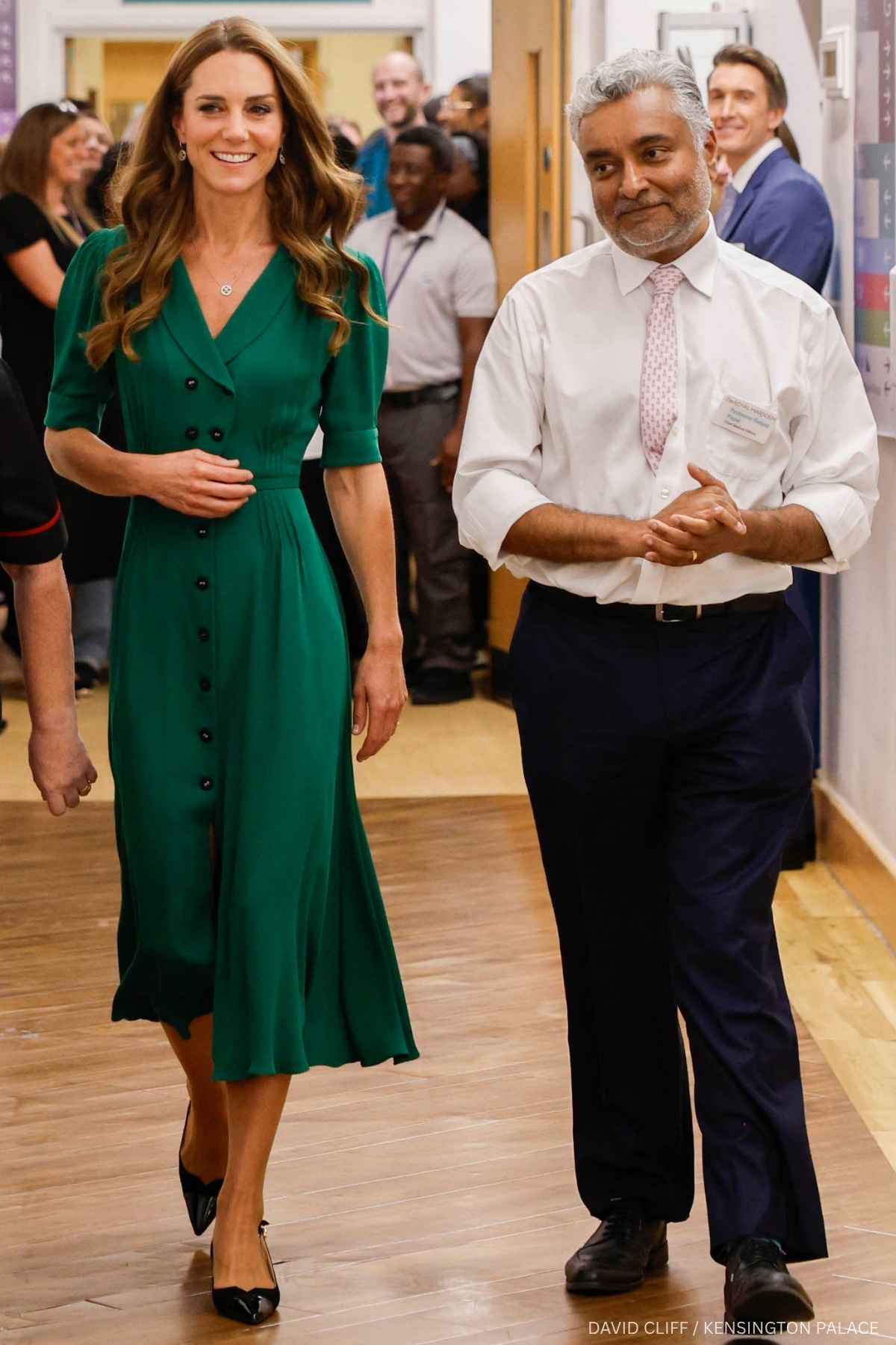 Kate Middleton wearing an emerald green Suzannah London dress with black slingback shoes at the Royal Marsden Hospital